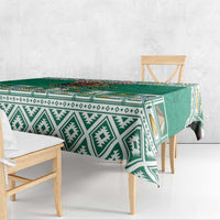 Green tablecloth with white Aztec diamond stripes and colorful Mexico emblem