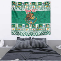 Rectangular green tapestry with central coat of arms and decorative Aztec-style stripes