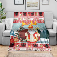 Personalized Christmas blanket draped on sofa, saint with staff, tree and gifts