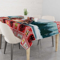 Red plaid Christmas tablecloth with blue tree scene panel, draped on a square table