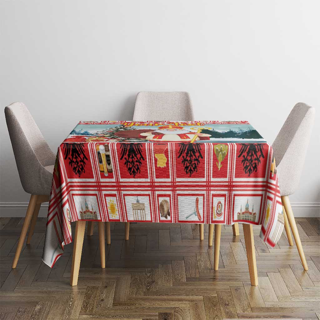 Red and green plaid Christmas tablecloth with holiday motifs, draped over a rectangular table