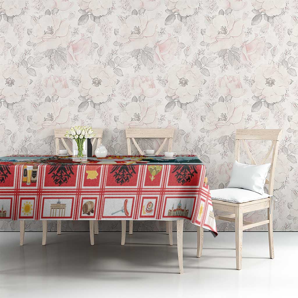 Red plaid Christmas tablecloth with small building and tree icons, covering dining table