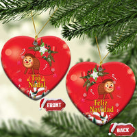 Red heart-shaped ceramic Christmas ornament with gold hanging loop; front and back labels