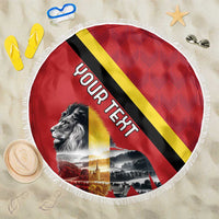 Round red beach blanket with Belgium flag stripes, lion graphic, and white fringe