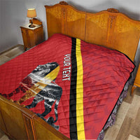Red quilt blanket on bed with black and yellow diagonal stripe and lion graphic