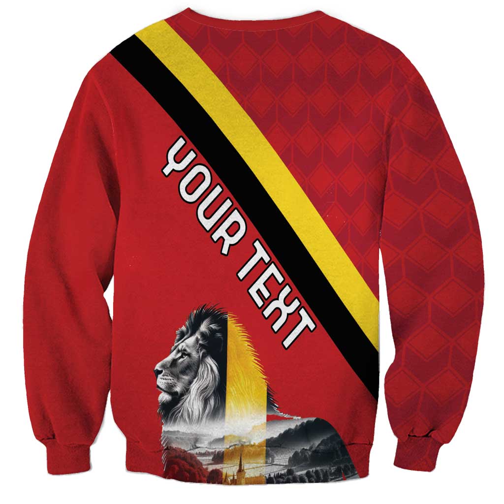 Red unisex sweatshirt with diagonal Belgium flag stripe, lion graphic, and large lettering