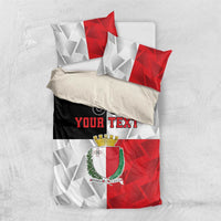 Malta bedding set laid flat with red and white geometric pattern, crest, and 'YOUR TEXT'