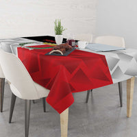 Red and white custom printed rugby tablecloth with geometric shapes on dining table.