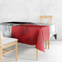 Red and white rugby tablecloth with geometric print, shown on a covered picnic table.
