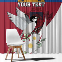 Close view of window curtain with blue-red panel and bird, flowers, and banner text