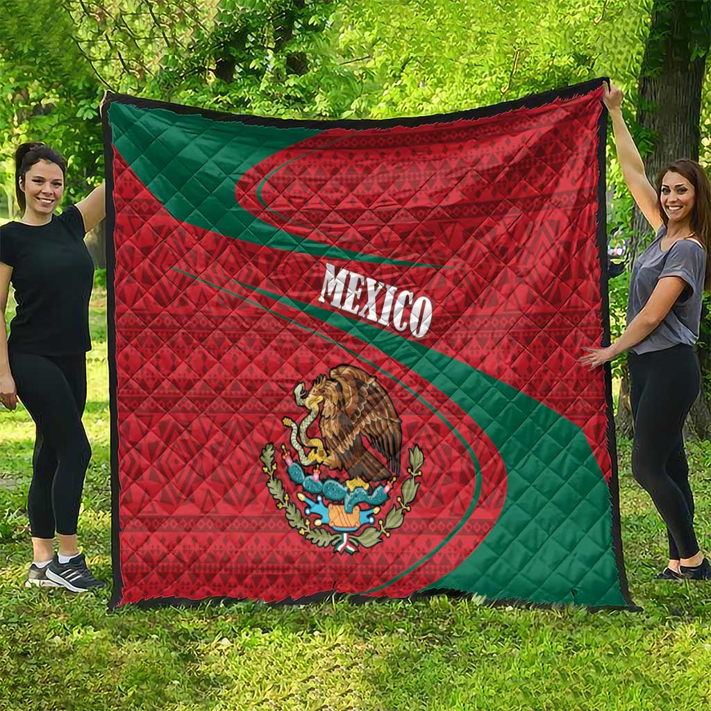 Mexico quilt hanging outdoors, red diamond design with green diagonal stripe and coat of arms
