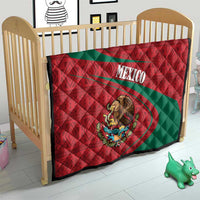 Mexico quilt on a toddler bed, red and green geometric pattern with coat of arms center