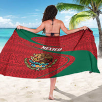 Red and green folk-pattern Mexico sarong with MEXICO text and lion crest, worn from back