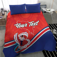 Red and blue bedding set with two blue pillows; duvet shows “Your Text” and Costa Rica dancer artwork