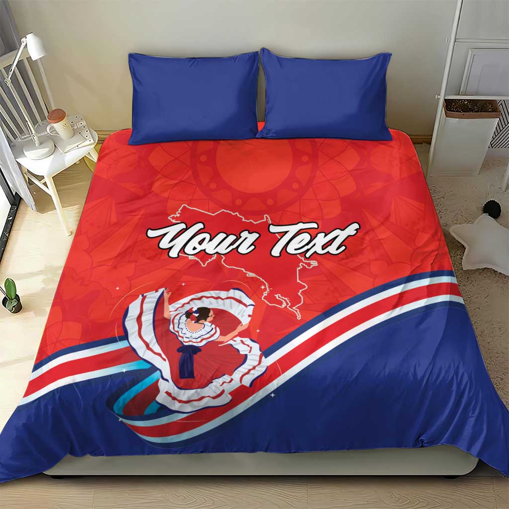 Red and blue comforter bedding set with two blue pillows; shows “Your Text” and Costa Rica design