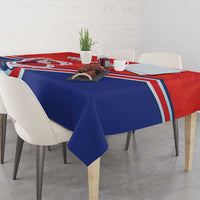 Personalized red and blue tablecloth draped on dining table with folk art border