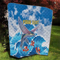 Personalized blue quilt featuring flying fish, red blossoms, and 'YOUR TEXT' title