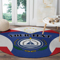 Blue round rug with Cabo Verde crest and red/white corner arcs, 'YOUR TEXT' headline