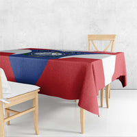 Blue, red, and white Cape Verde crest tablecloth draped over a dining table