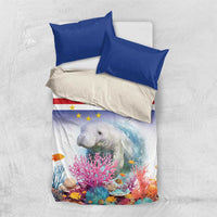 Manatee bedding set flat lay: blue top pillows and star-striped coral reef design