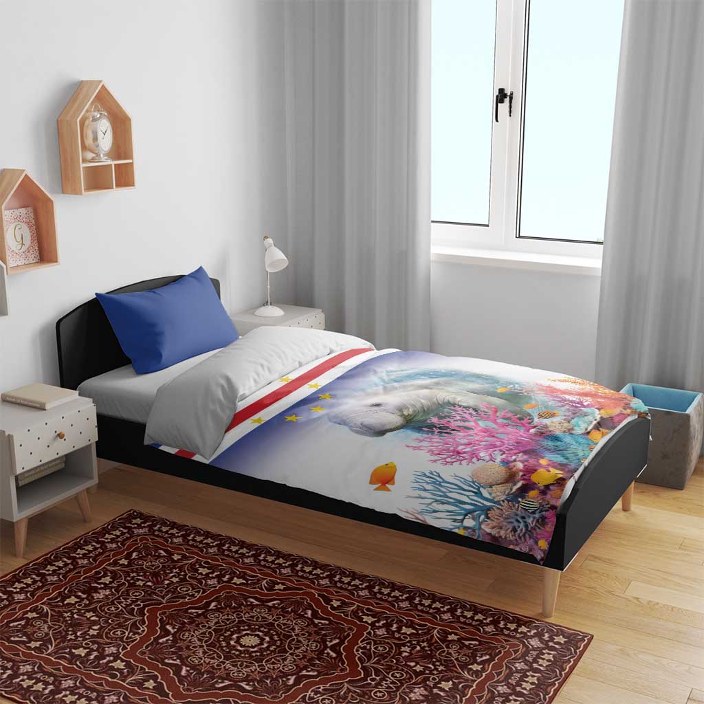Manatee duvet cover on bed with blue pillows and coral reef star-striped flag pattern