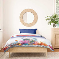 Blue and white manatee bedding set on bed with coral reef and star-striped design