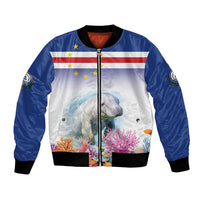 Blue bomber jacket with zip front, black ribbed cuffs, manatee reef graphic and flag panel