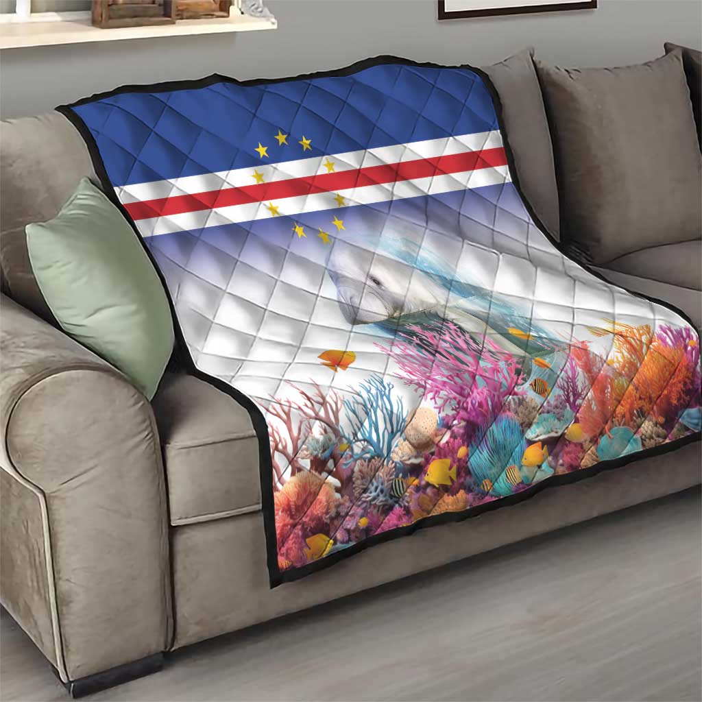 Quilt on sofa with Cape Verde flag stripes, star emblem, and manatee over coral