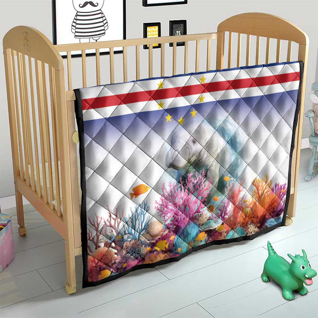 Quilt in baby crib with Cape Verde flag stripes, stars, and manatee coral reef print