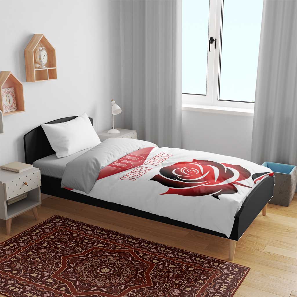 White bedding set with red rose design, 'YOUR TEXT' lettering, and '00' logo