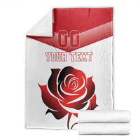 Custom rugby-style blanket with red-and-white rose design, “YOUR TEXT,” and folded stack