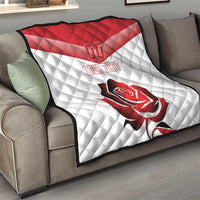 Red and white quilt blanket on couch with rose graphic and “YOUR TEXT”