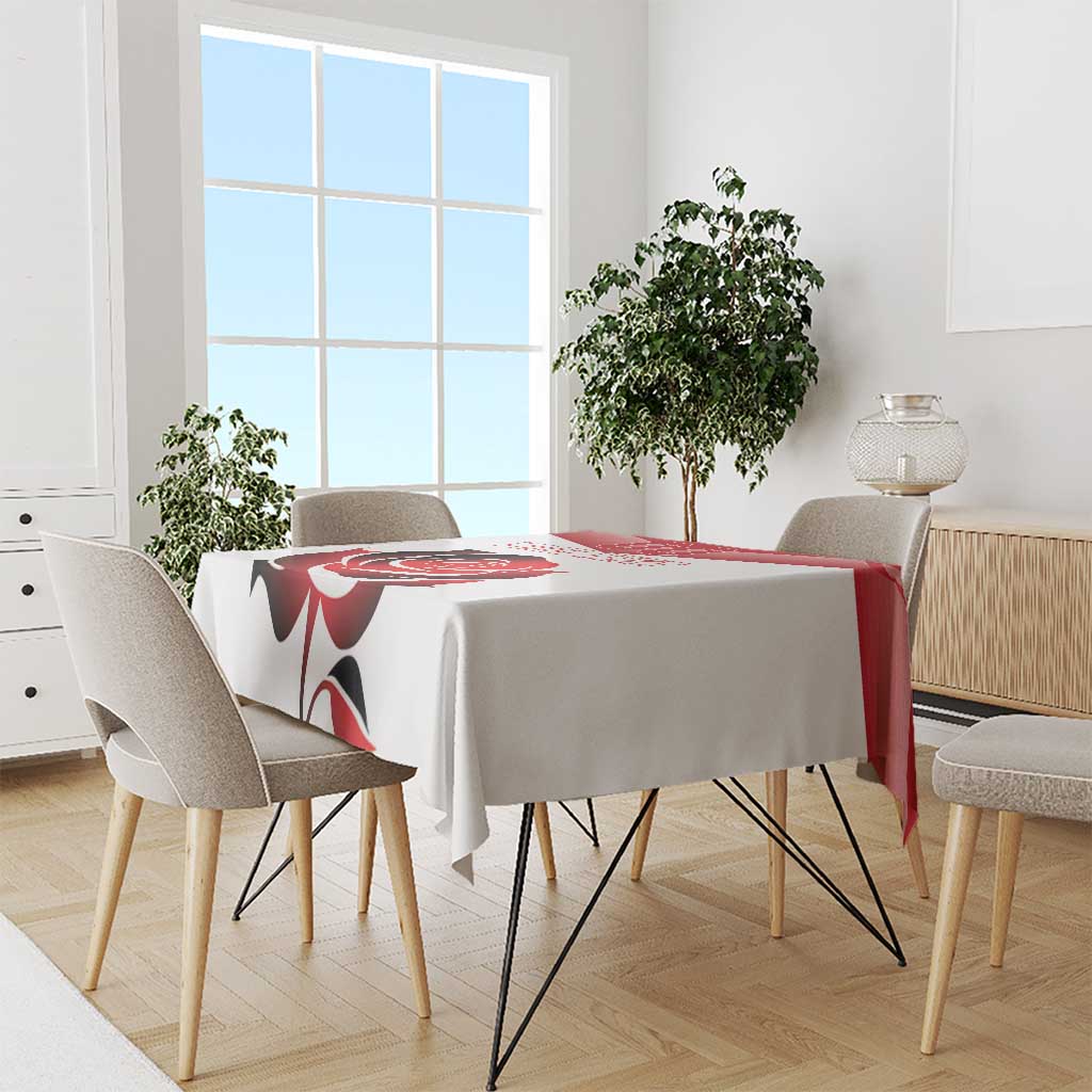 Red rose design custom tablecloth draped over a dining table with chairs