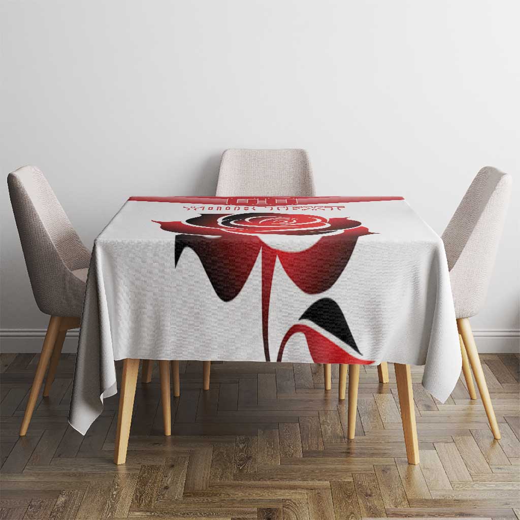 Custom tablecloth with large red flower and black details, centered on a square dining table