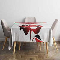 Custom tablecloth with large red flower and black details, centered on a square dining table