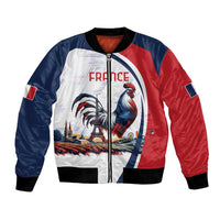 Unisex bomber jacket in red/blue with rooster and Eiffel-themed print, black ribbed cuffs.
