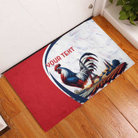 Personalized rubber doormat with red border and blue rooster illustration, 'YOUR TEXT' banner