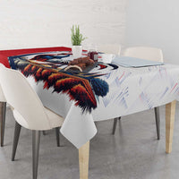 Rooster and Eiffel Tower tablecloth with red and blue border, draped across dining table