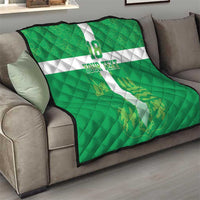Green football quilt blanket on sofa with white cross, number 18, and custom text