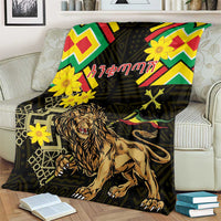 Black lion of Judah folk blanket with yellow flowers and bright chevrons, on a couch.