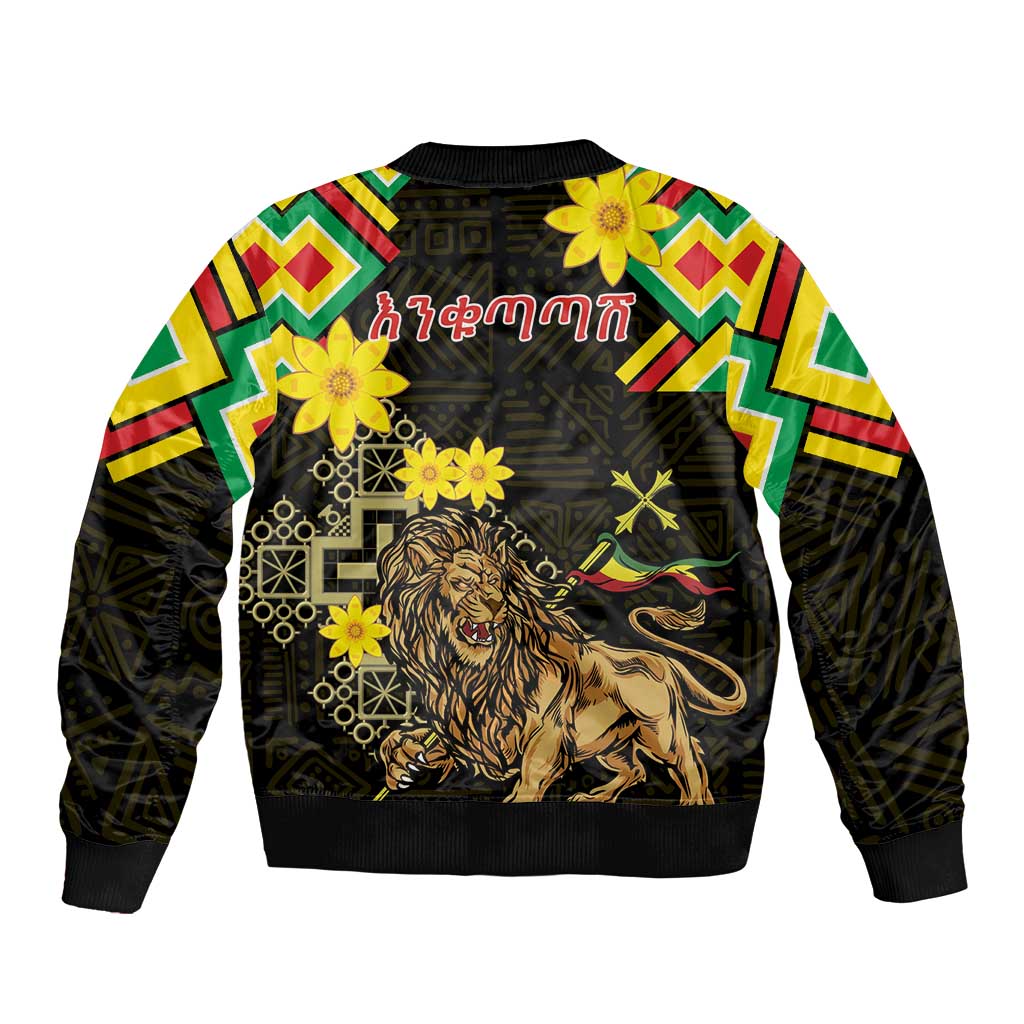 Unisex black bomber jacket with folk trim sleeves, lion graphic with flowers and geometric motifs