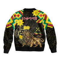 Unisex black bomber jacket with folk trim sleeves, lion graphic with flowers and geometric motifs