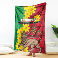Ethiopia-themed throw blanket with flower pattern, lion figure, and ETHIOPIA text, laid on floor