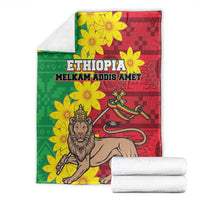Ethiopia-themed blanket folded with green and red floral design, lion figure, ETHIOPIA text