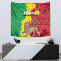Green and red Ethiopian-style tapestry with lion, yellow blossoms, and emblem graphics