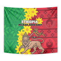 Close-up wall tapestry with green and red blocks, lion portrait, and yellow flower details