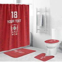 Red bathroom set with shower curtain and matching floor rugs near the toilet
