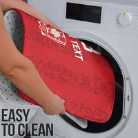 Red bath mat being cleaned in a washing machine