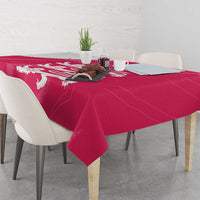 Pink tablecloth with white lion motif across the tabletop and down the sides.