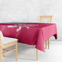 Pink tablecloth with white lion crest, hanging over the table edge.